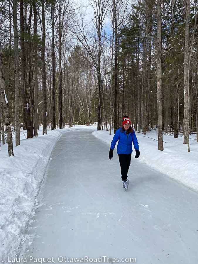 woman skating toward camera on laurentian valley skate trail through the forest