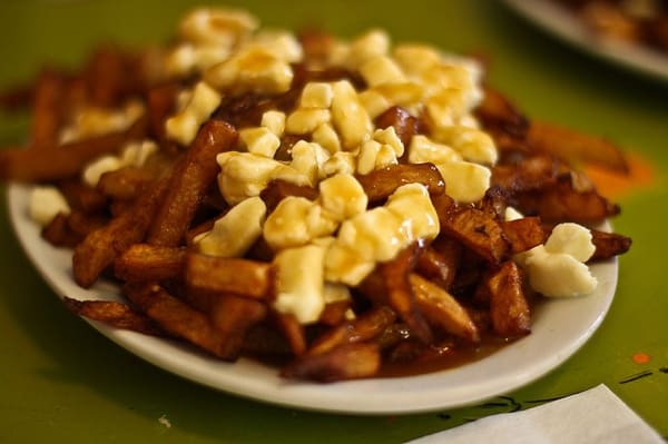 at a poutine festival (aka a poutinefest) in ottawa or eastern ontario, you might find poutine like this heap of fries on a white plate!