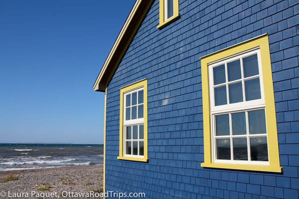 shop in a blue house overlooking the ocean on quebec's Iles de la Madeleine.