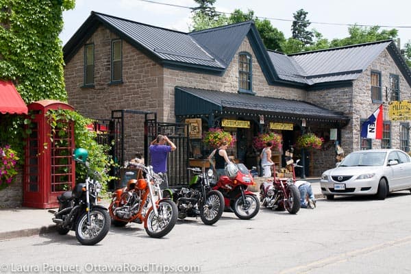 motorcycles parked in front of a cute shop in merrickville, ontario.