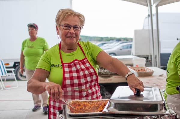 Woman serving baked beans.