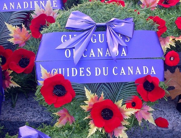 Remembrance Day wreath with poppies and purple bow from the Girl Guides of Canada.