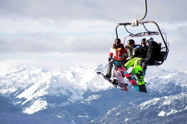 Snowboarders on a lift in Whistler. Photo by Pamela Saunders on Unsplash.