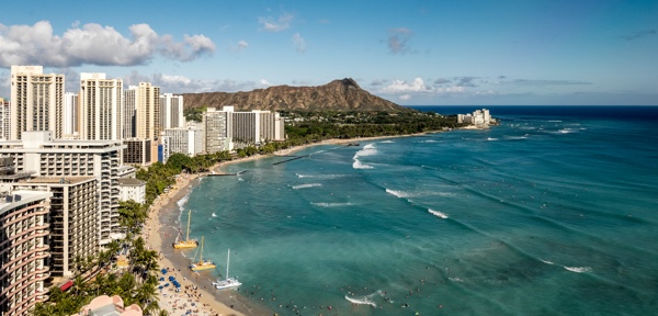 Waikiki Beach in Honolulu, Hawaii, from above with towers along beach.