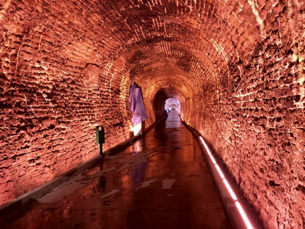 Brockville Railway Tunnel illuminated with red light. Photo by Laura Byrne Paquet.