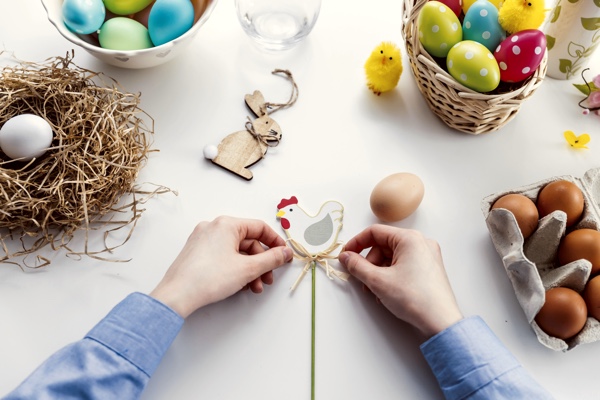 Hands making Easter crafts. Photo by JESHOOTS.COM on Unsplash.