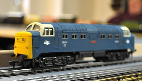 Blue and yellow Amtrak model train locomotive.