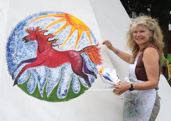 Katharine Fletcher completes her Spirit Horse on the Pontiac Artists' Association Teepee at the Shawville Fair. Photo courtesy of Katharine Fletcher.