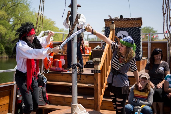 Costumed actors swing swords aboard the Island Rogue in Toronto, part of the Pirate Life attraction. 