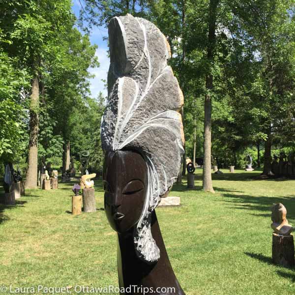 sculpture of a woman's head, titled "Confidence," by Zimbabwean artist Tutani Mgabazi, in the outdoor exhibition at the ZimArt Rice Lake Gallery in Bailieboro, Ontario, near Peterborough.