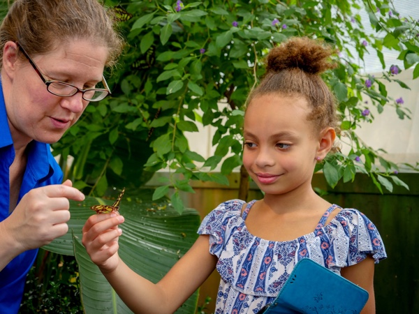 educator and young girl with butterfly at the canadian museum of nature in ottawa.