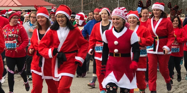 runners and walkers in Santa suits