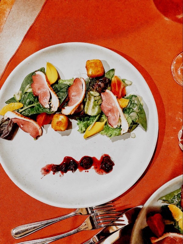 Duck with greens and a honey vinaigrette at Canthooks Restaurant at Calabogie Peaks Resort.