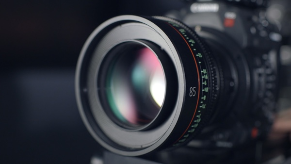 Closeup of a DSLR camera lens. Photo by ShareGrid on Unsplash.