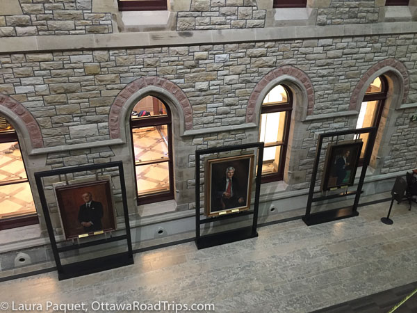 official portraits of former prime ministers brian mulroney, john turner and joe clark are on display at the back of the temporary house of commons chamber in the west block on parliament hill in ottawa.