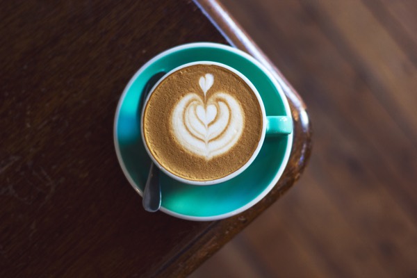 coffee with a cream pattern, in a green cup and saucer