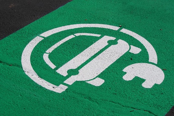 logo of an electric car painted on asphalt of electric car parking spot