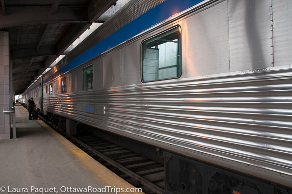 the exterior of a via rail passenger car. if you take the train from ottawa to toronto, you can relax or work quite comfortably.