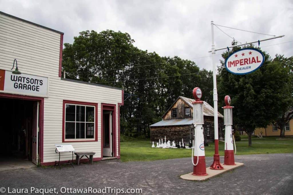 1940s gas pumps in front of a vintage gas station building at the cumberland village heritage museum