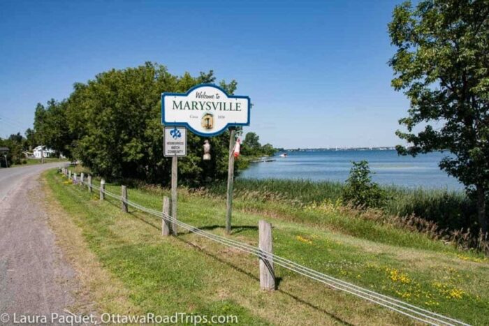 quiet country road with sign saying Marysville and with Lake Ontario on the right