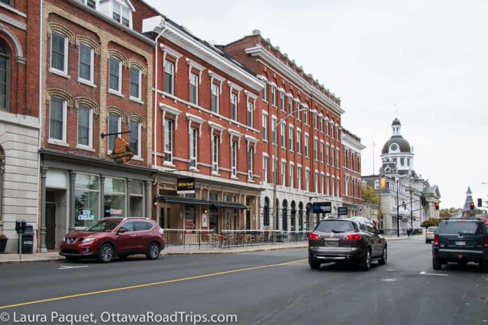 line of red brick shops with domed kingston city hall in background