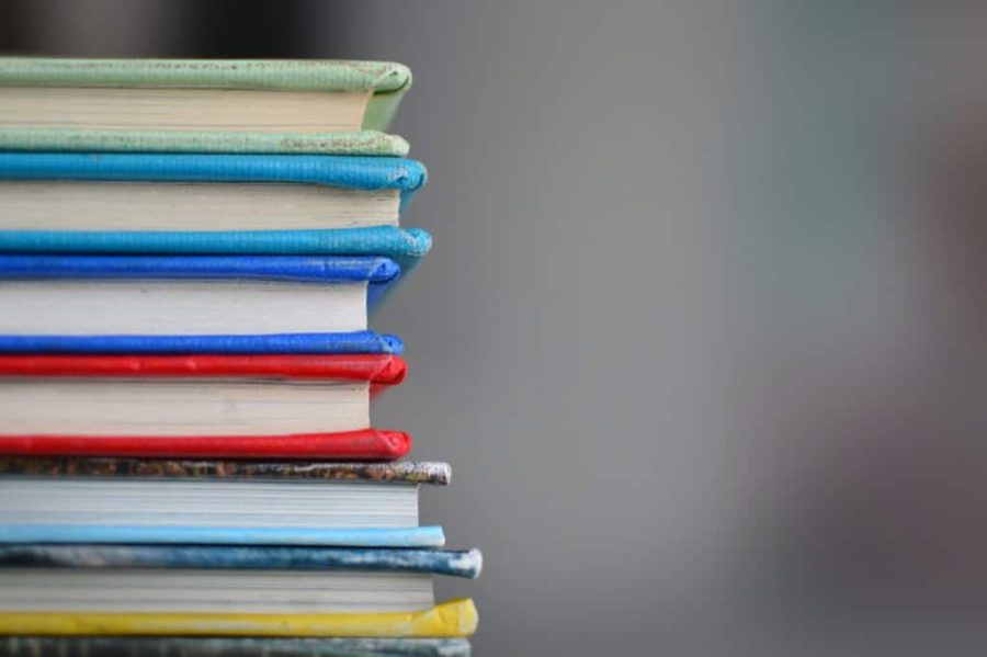 a stack of books with multicoloured covers, photographed from the side