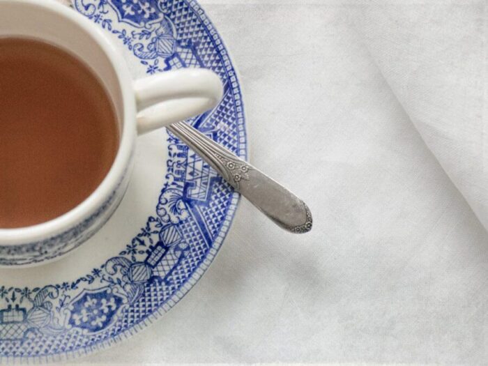 tea in a white cup on a blue and white saucer