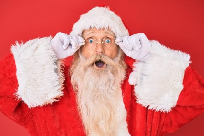 surprised-looking santa against a red background