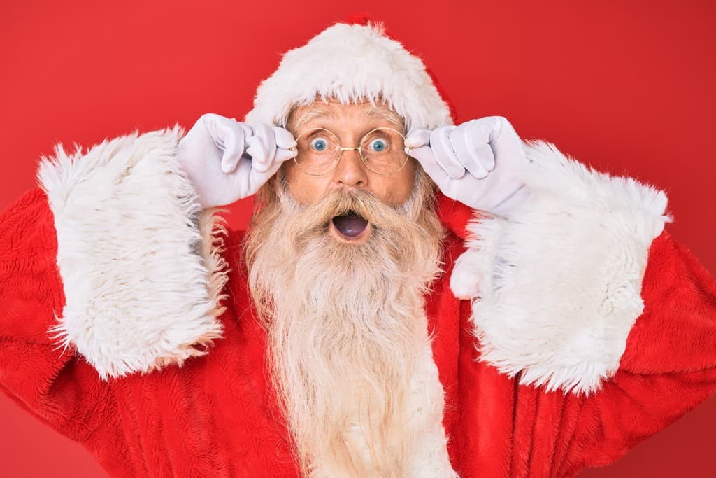 surprised-looking Santa against a red background