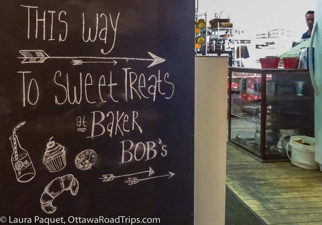 white chalk sign on blackboard with pictures of baked goods at baker bob's in Almonte, Ontario.