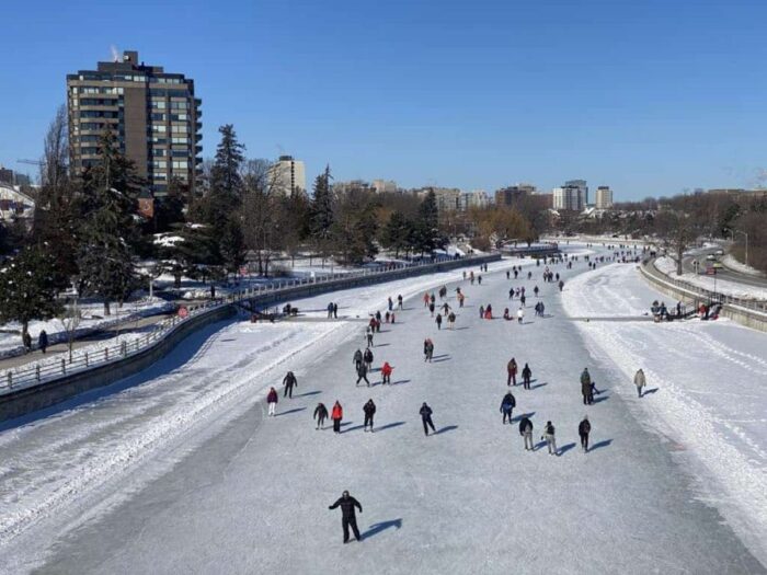 skaters on the rideau canal near fifth avenue, taken from flora footbridge