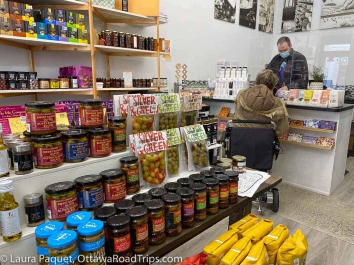 store interior with wooden shelves of bottled foods