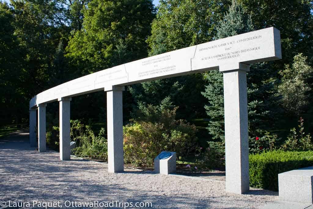 a large stone memorial sculpture at the canadian heritage garden at rideau hall in ottawa
