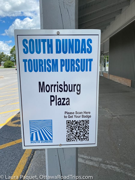 qr code on a blue and white sign at morrisburg plaza.