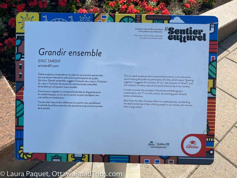 colourful plaque along the sentier culturel in gatineau, providing background information on grandir ensemble by eric tardif.