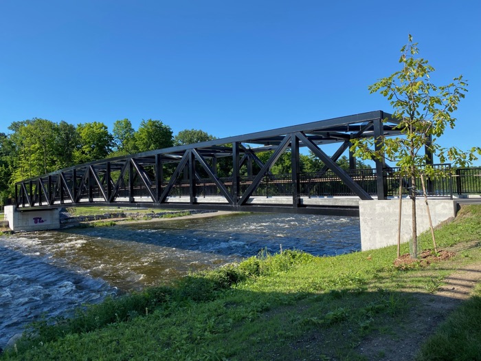 cycling and pedestrian bridge crossing rapids on rideau river at carleton university