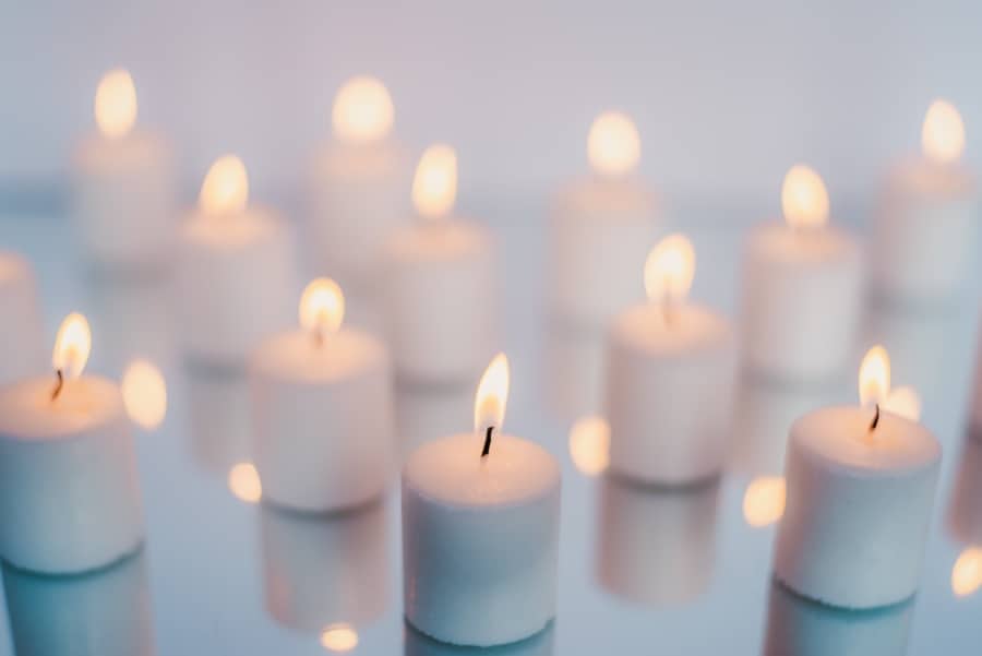 white votive candles against a blurred background