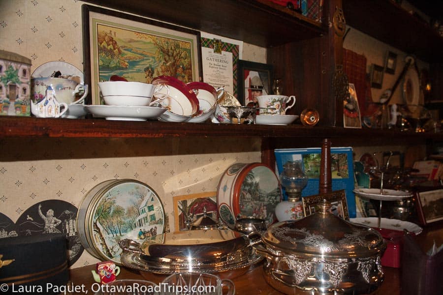 antique dishes and memorabilia displayed on a wooden hutch at brigadoon restaurant in oxford mills, ontario