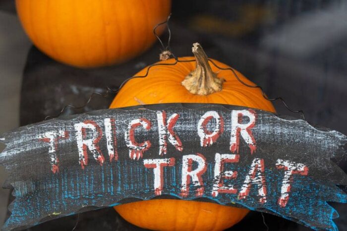 nick-fewings-halloween-trick-treat-unsplash - Ottawa Road Trips pumpkins and a banner reading trick or treat