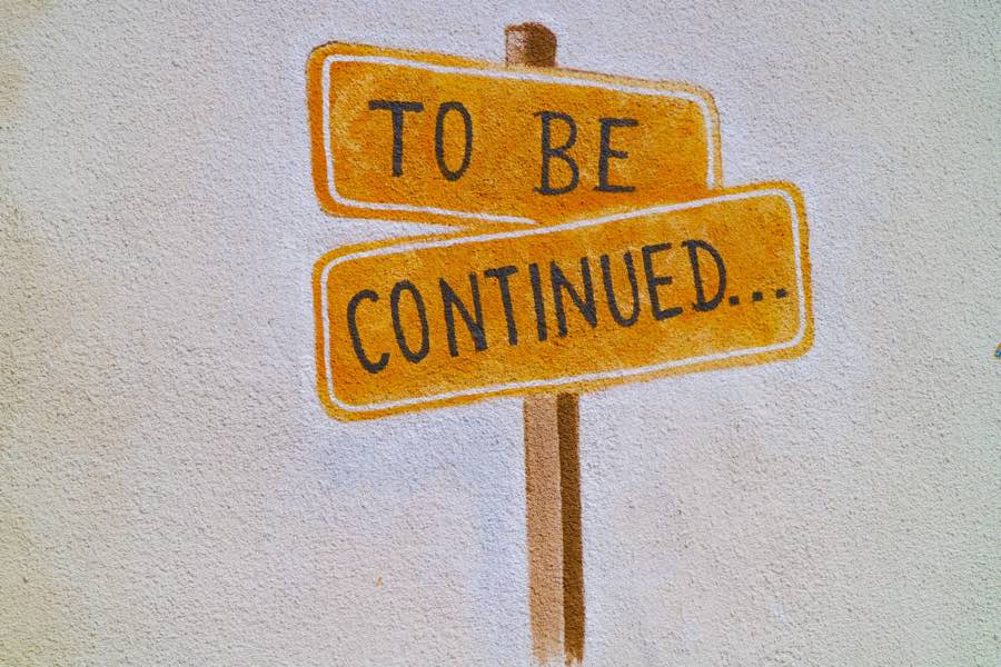 Illustration of an orange signpost with black letter reading "to be continued"