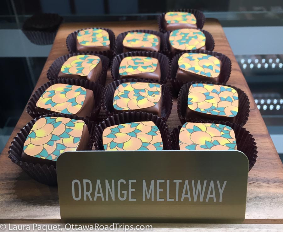 closeup of square chocolates with design of oranges on top
