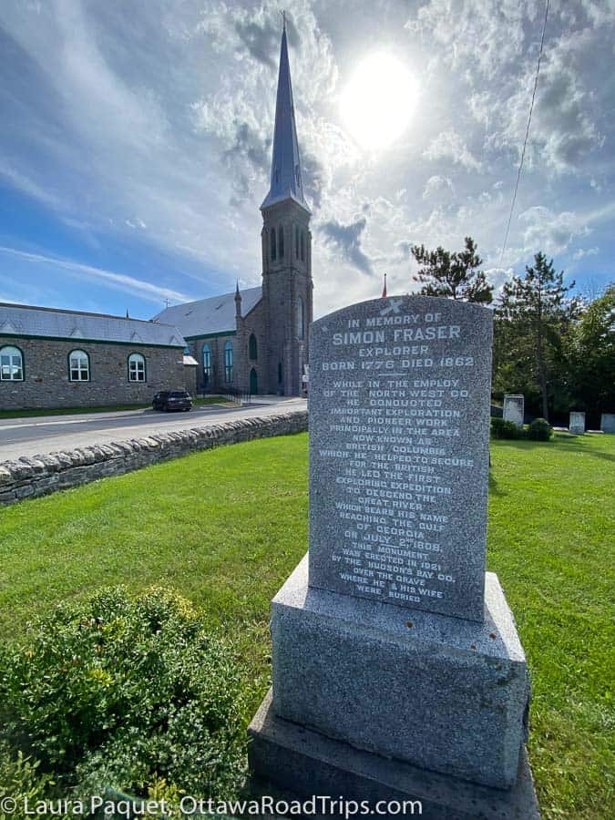 simon fraser gravestone with large church in background in st. andrews west, ontario.