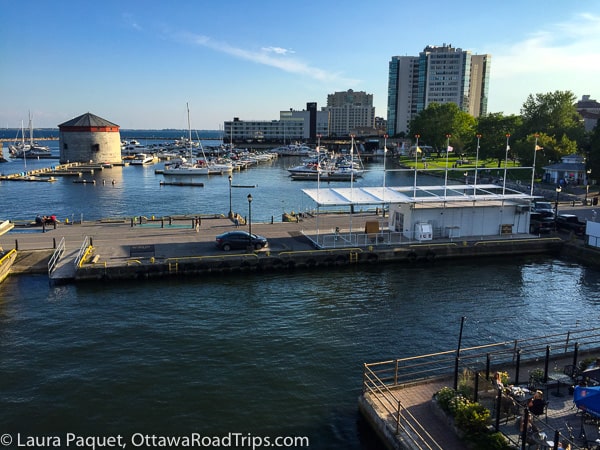 waterfront in kingston ontario with martello tower, marina, restaurant terrace and apartment blocks