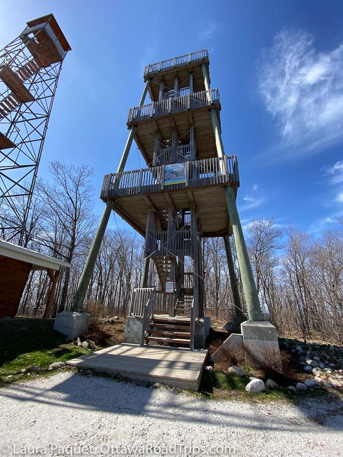 the old metal fire tower (at left) and the new wooden observation tower on mont morissette in blue sea, quebec.