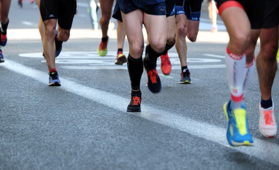 Closeup of runners' feet during a road race.