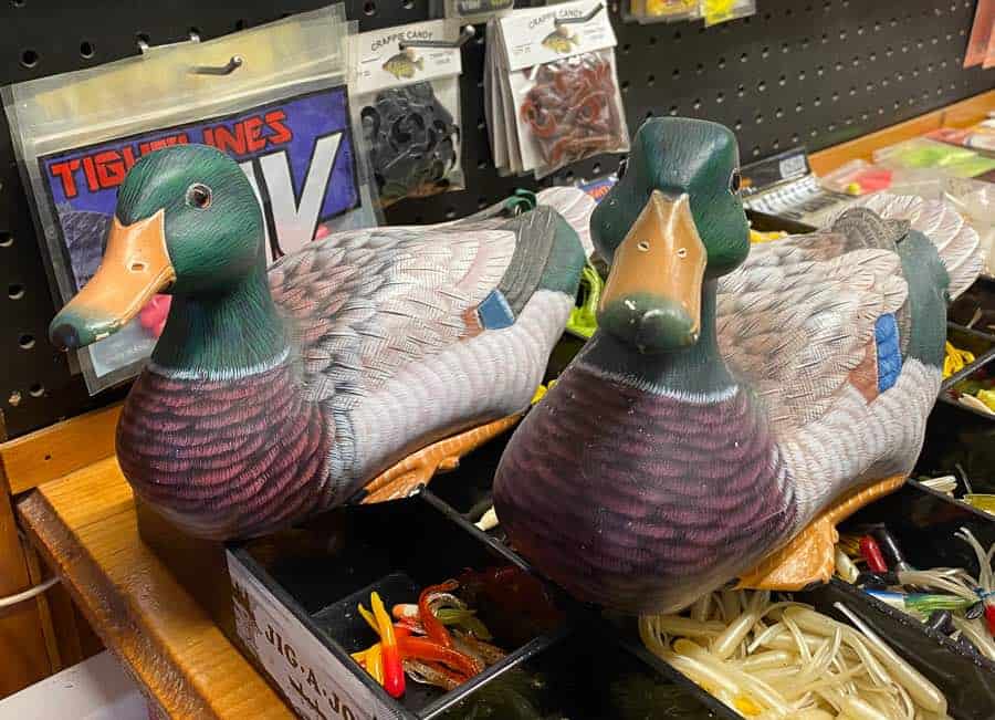 duck decoys on a shelf with fishing lures at norris's Bait and Tackle in Newboro in Rideau Lakes.