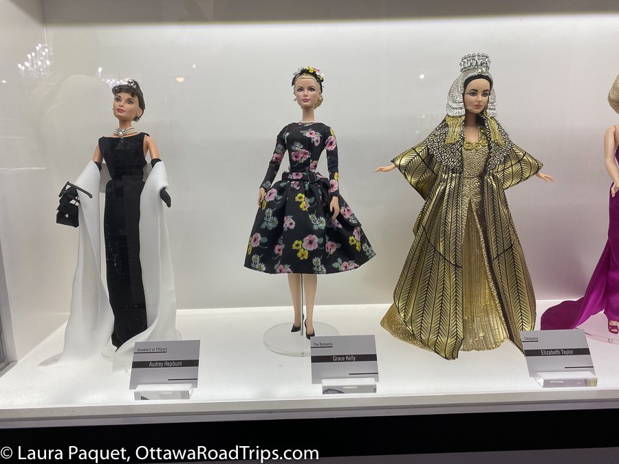 audrey hepburn doll in long black dress, grace kelly doll in a 1950s flowered dress with wide skirt, liz taylor doll dressed as cleopatra