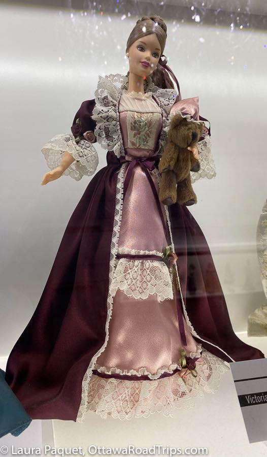 barbie in a purple victorian dress with pink underskirt and lace trim