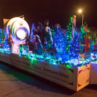 parade float with blue Christmas lights and giant candy canes