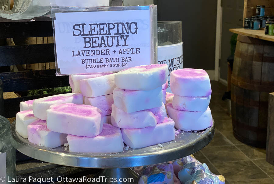 Pink and white bubble bath bars on a metal table.